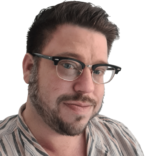 Profile photo of Kieran, a man with short brown hair and a short beard wearing glasses and smiling at the camera.