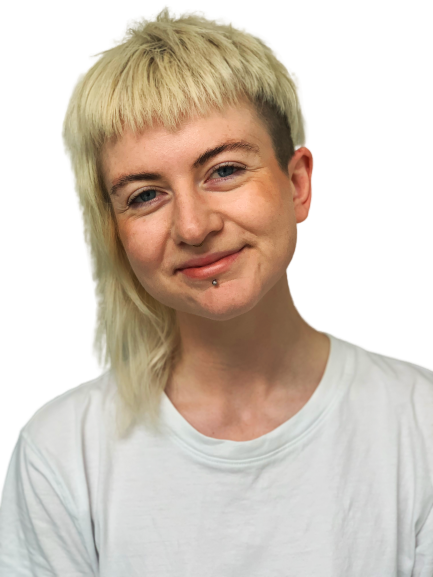 Profile photo of Jesse, a white person with bleached blonde hair who is smiling at the camera. They are wearing a white t-shirt.