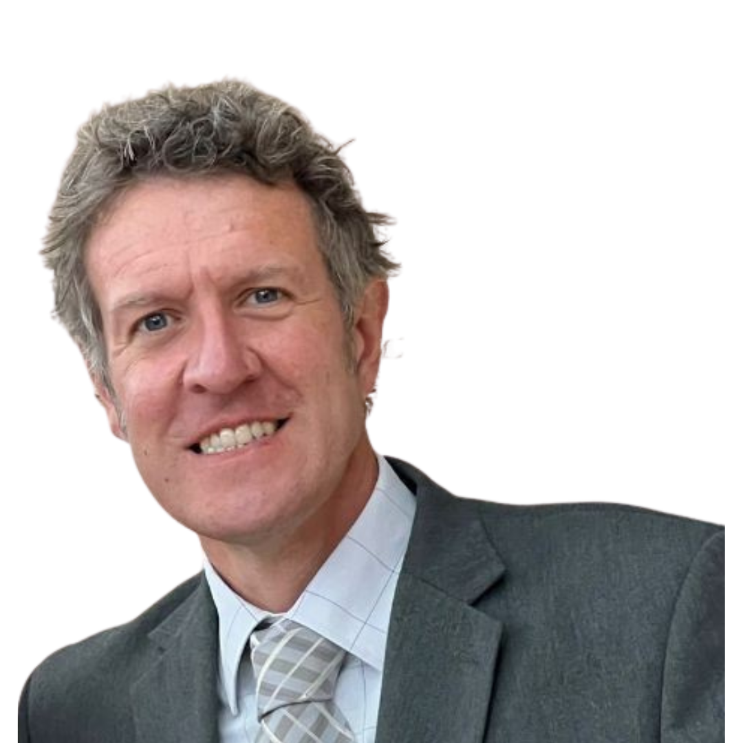 A smiling white man with curly salt and pepper hair wearing a grey suit.