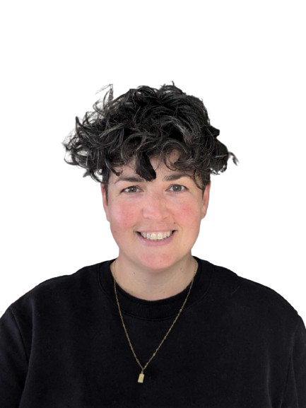 Profile photo of Anna, a white woman with short, brown curly hair, who is smiling at the camera.