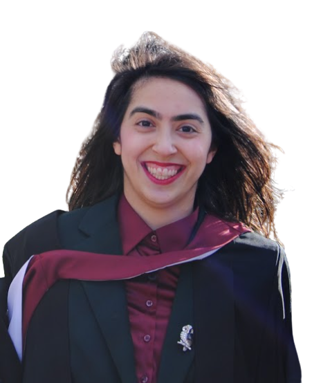 Profile photo of Lilit, smiling towards the camera with her long brown hair blown back messily by the wind. Lilit is wearing a maroon red shirt and dark green blazer, with her black university graduation gown falling off her shoulders.