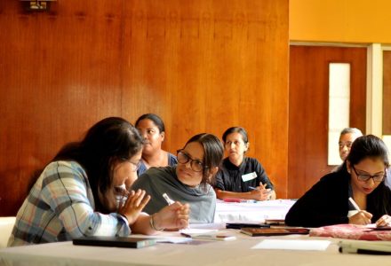 A group of people in a room at a training session. 